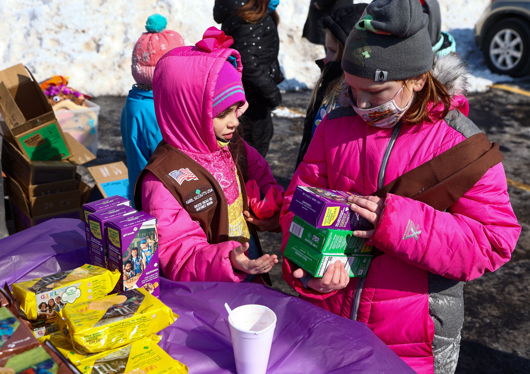Girl Scout troop holds a drive-thru cookie booth